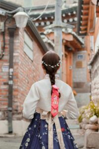 Woman in traditional Korean hanbok walking through Bukchon Hanok Village